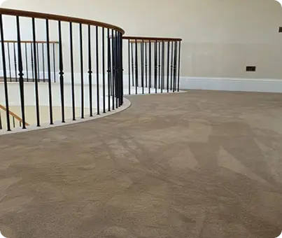 Dark-oak-hardwood-floors-on-an-upper-landing-with-curved-iron-staircase-railing