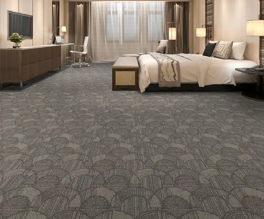 Elegant hotel room featuring grey patterned wall-to-wall carpeting with fan-shaped geometric designs